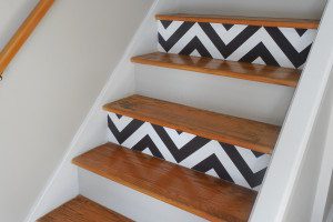 A staircase with black and white chevron pattern on the steps.