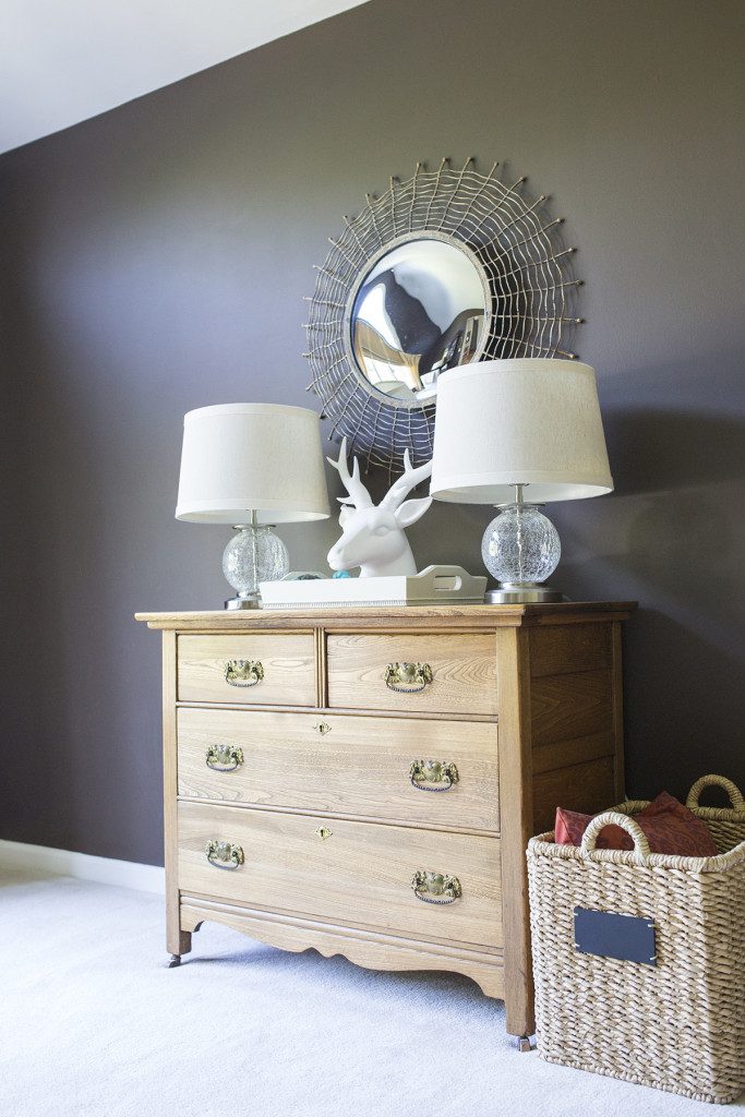 A dresser with two lamps and a mirror