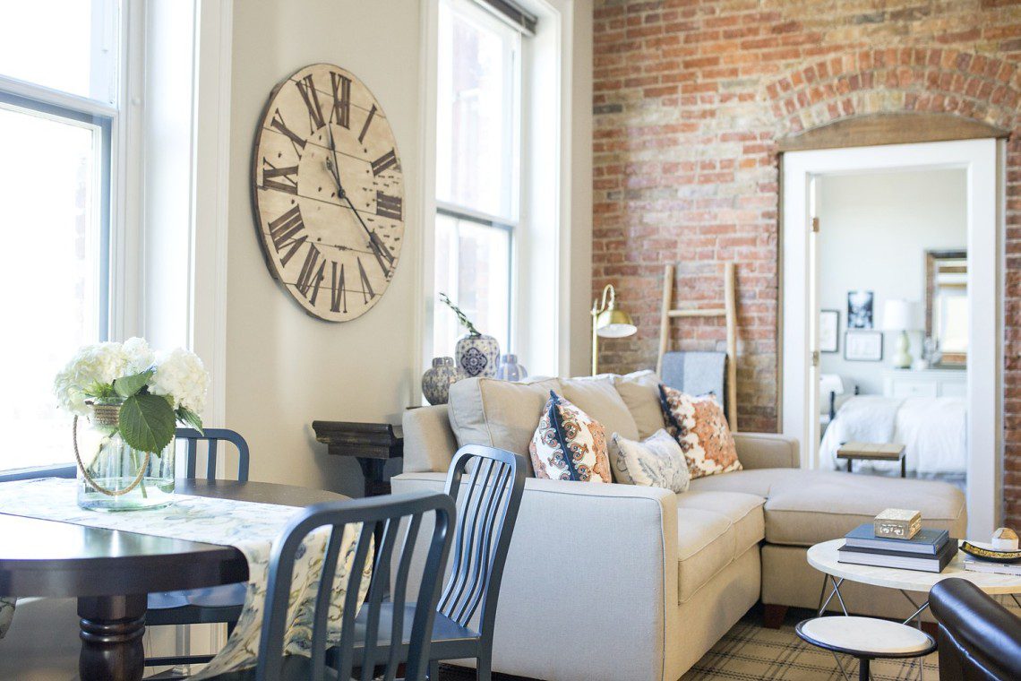 A living room with a couch and chairs in it