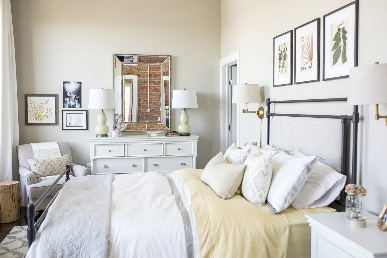 A bedroom with white furniture and a bed.