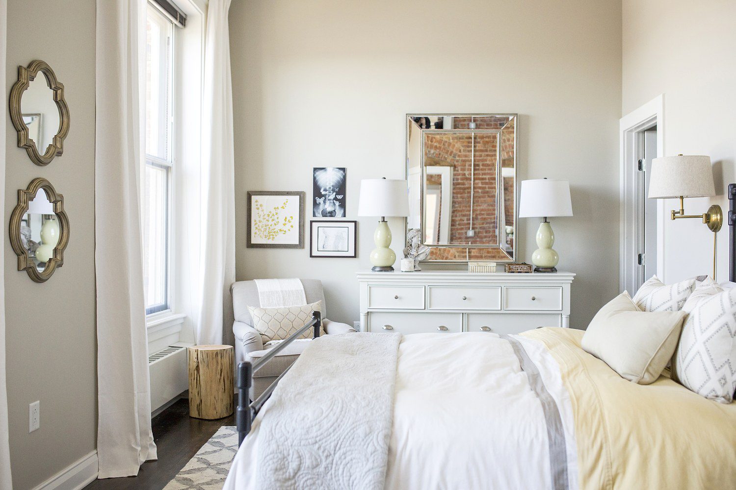 A bedroom with white walls and furniture.