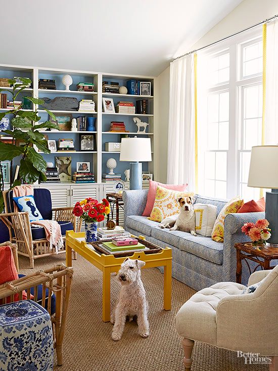 A living room with blue walls and yellow furniture.