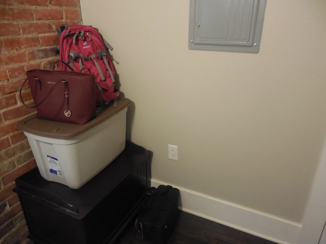 A room with two suitcases and a backpack.