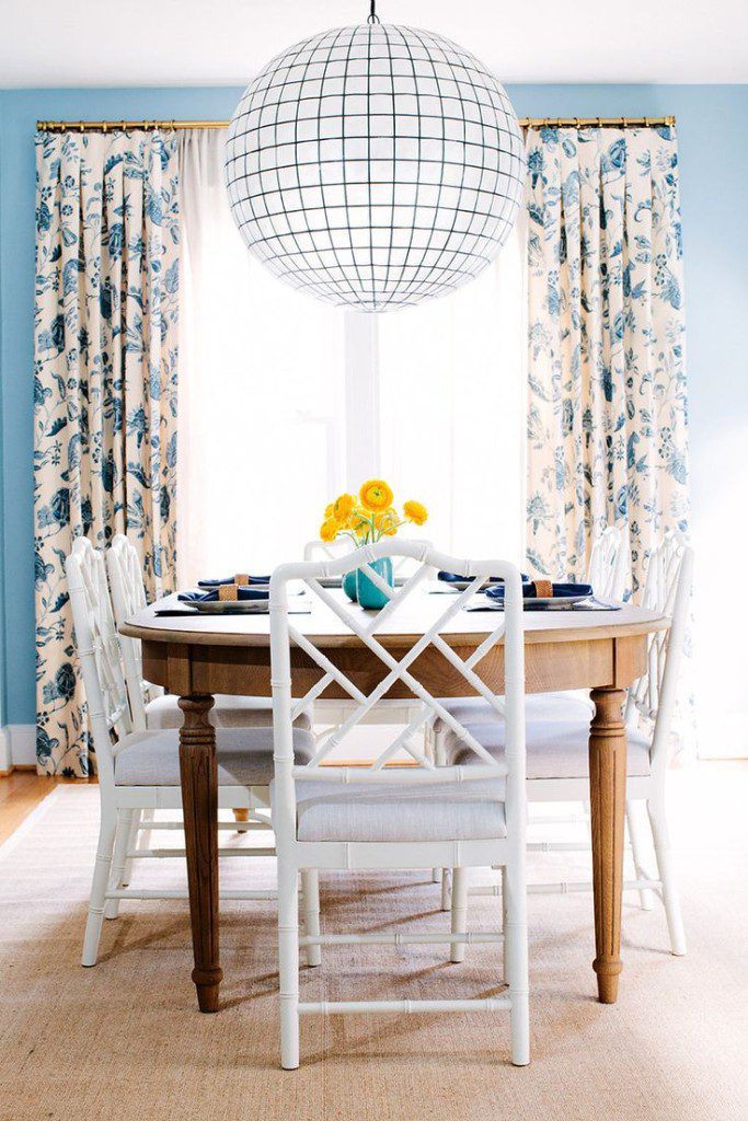 A living room with blue and white pillows on the couch.