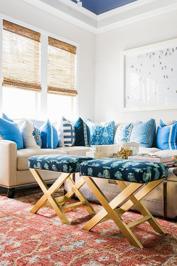 A living room with blue and white pillows on the couch.