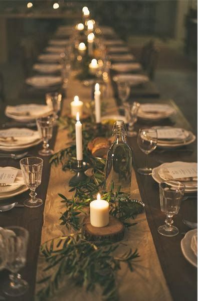 A long table with candles and plates on it