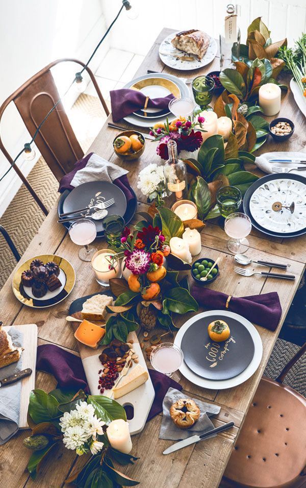 A table set with plates, silverware and fruit.