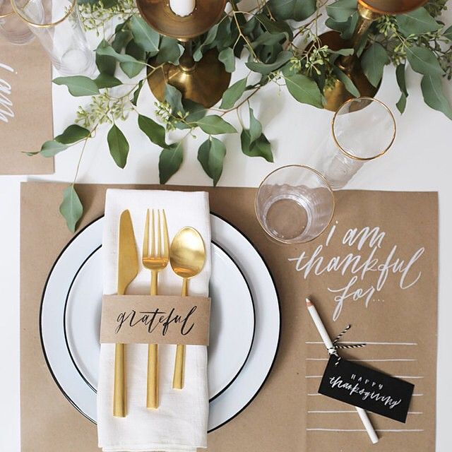 A table set with silverware and napkins for thanksgiving.