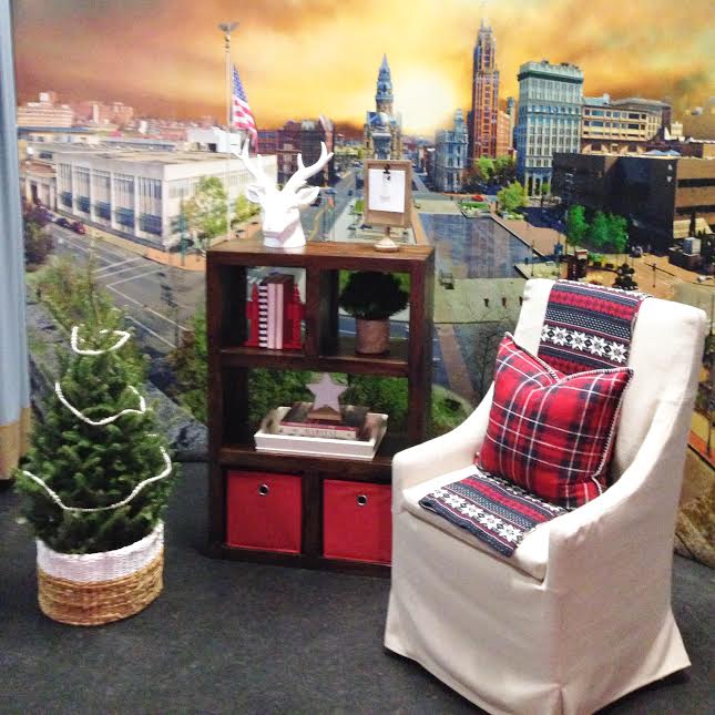 A chair and table in front of a wall mural.