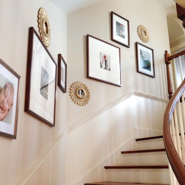 A staircase with many pictures on the wall