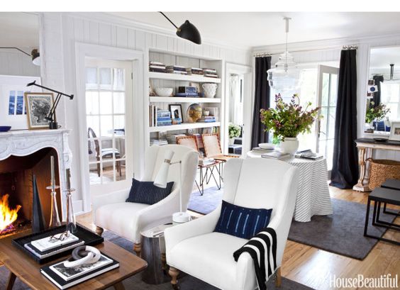 A living room with white furniture and black accents.