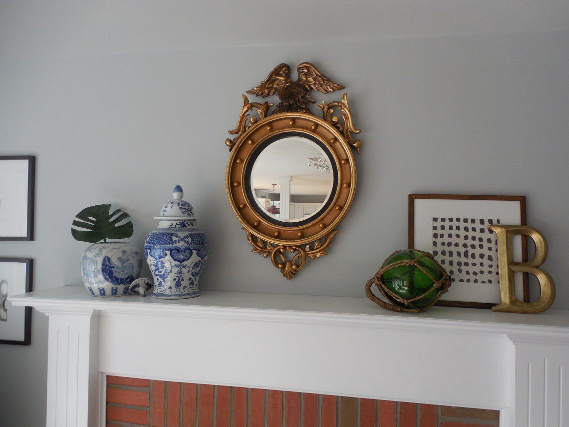 A mirror sitting on top of a mantle.
