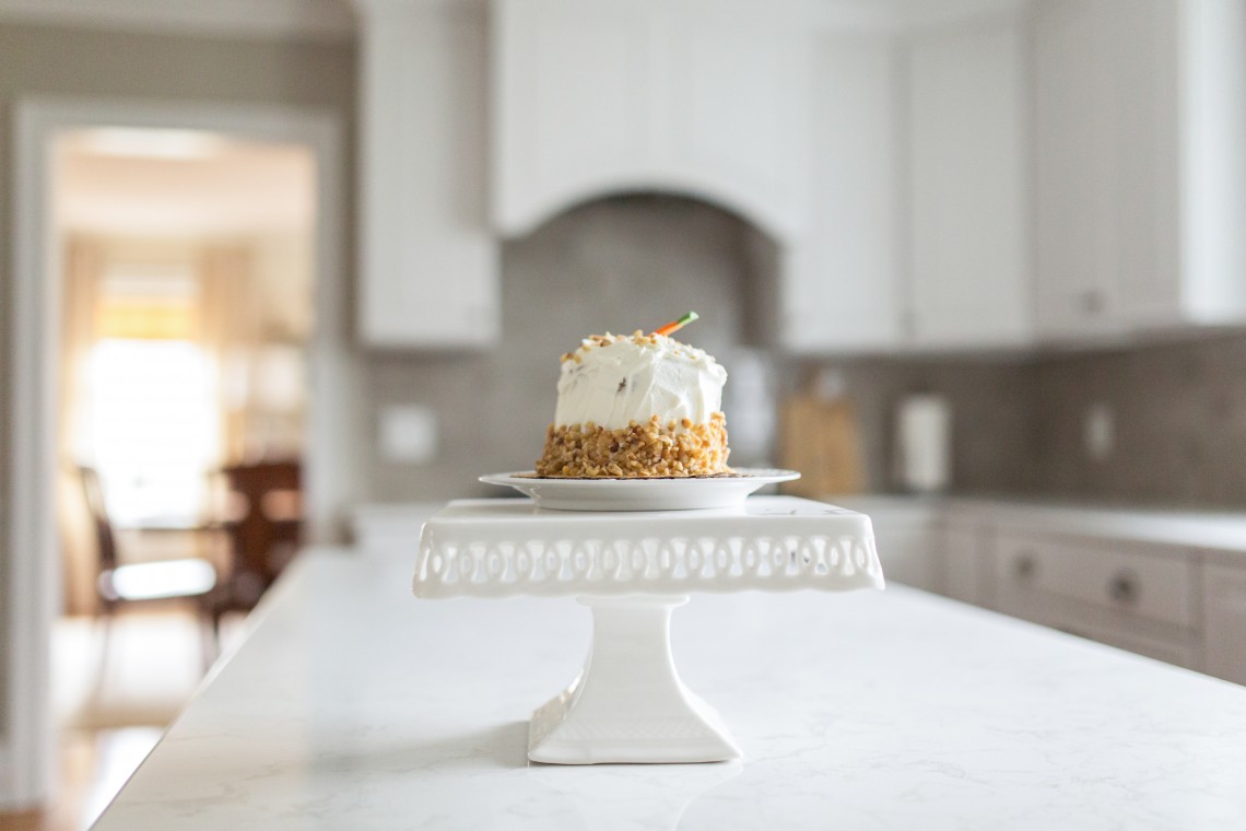 A cake on top of a white pedestal.
