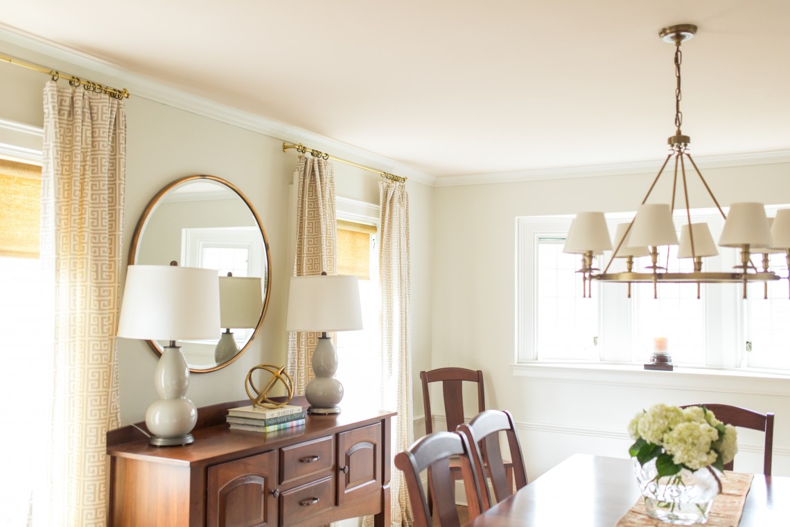 A dining room table with chairs and lamps on it.