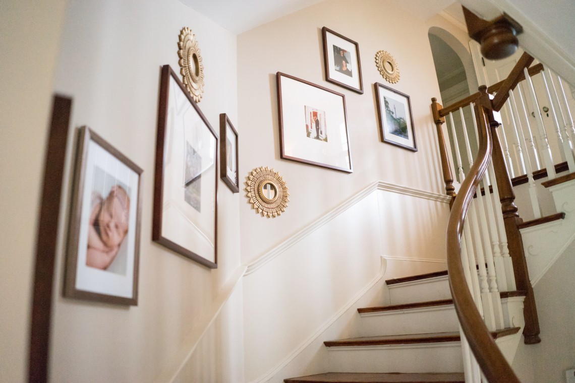 A staircase with many pictures on the wall