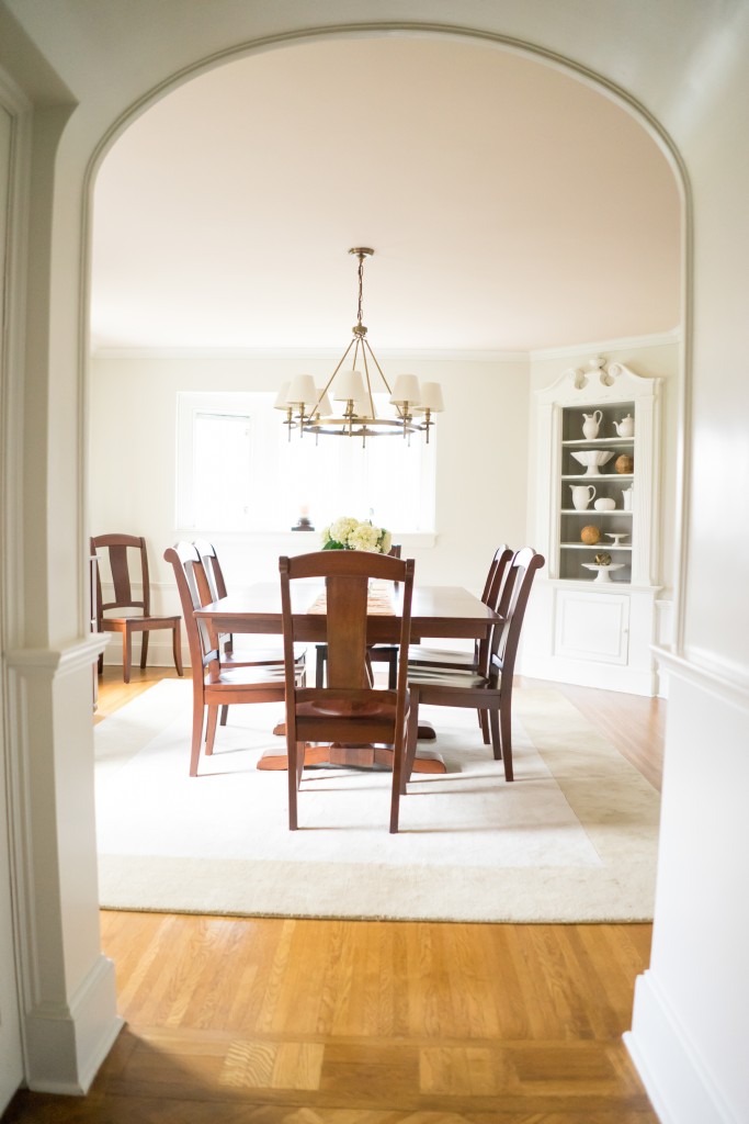 A dining room with a table and chairs in it