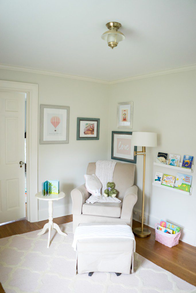 A white chair and ottoman in a room.