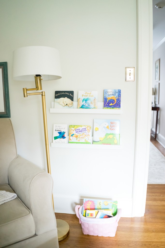 A white couch and lamp in a room.