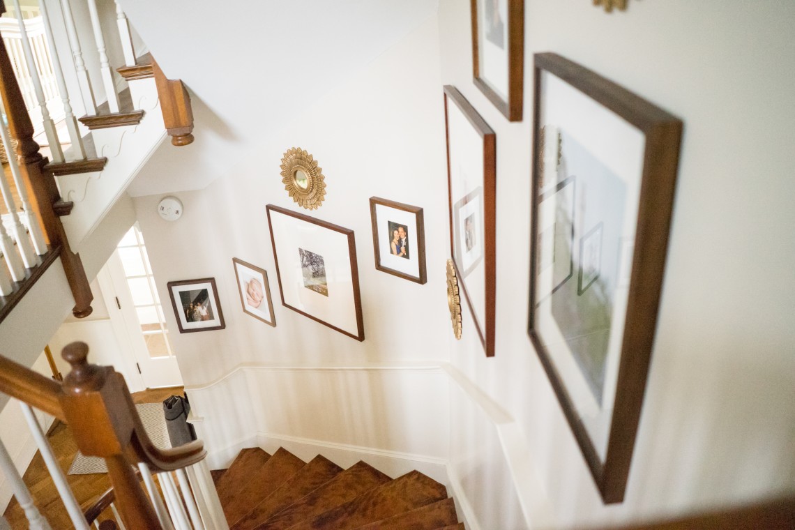 A staircase with many pictures on the wall