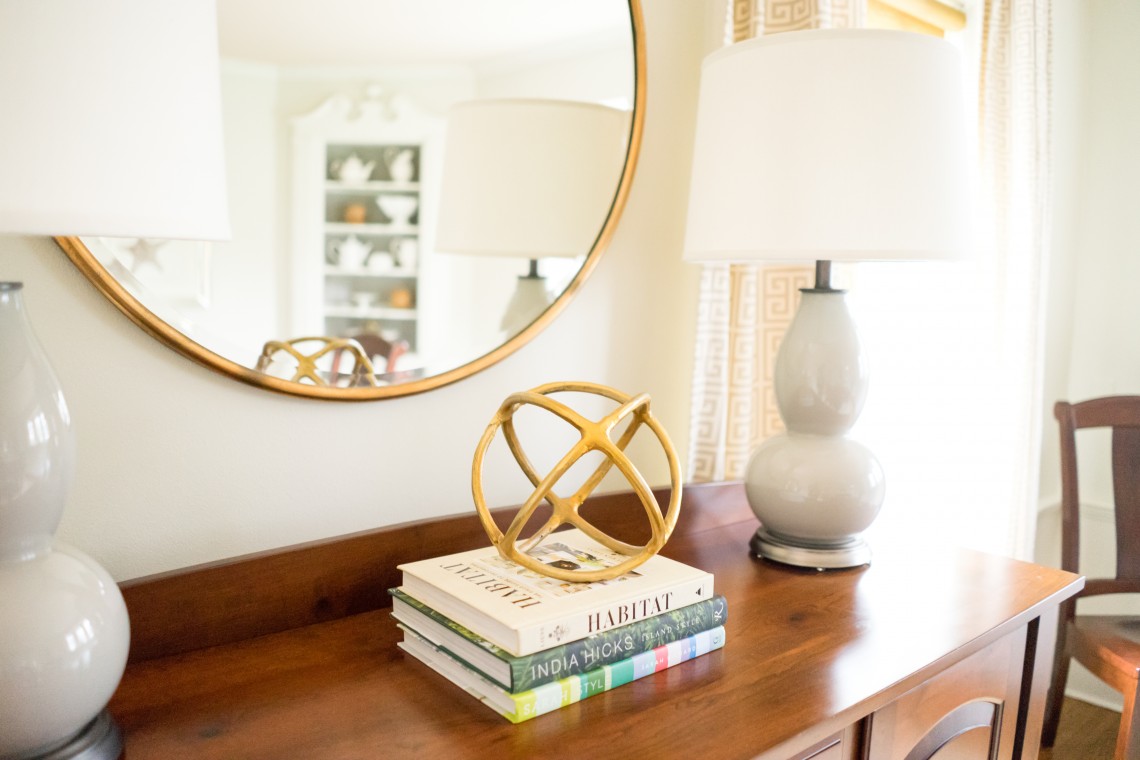 A mirror and some books on the table