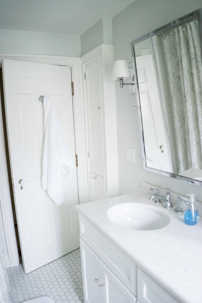 A bathroom with white walls and a sink.