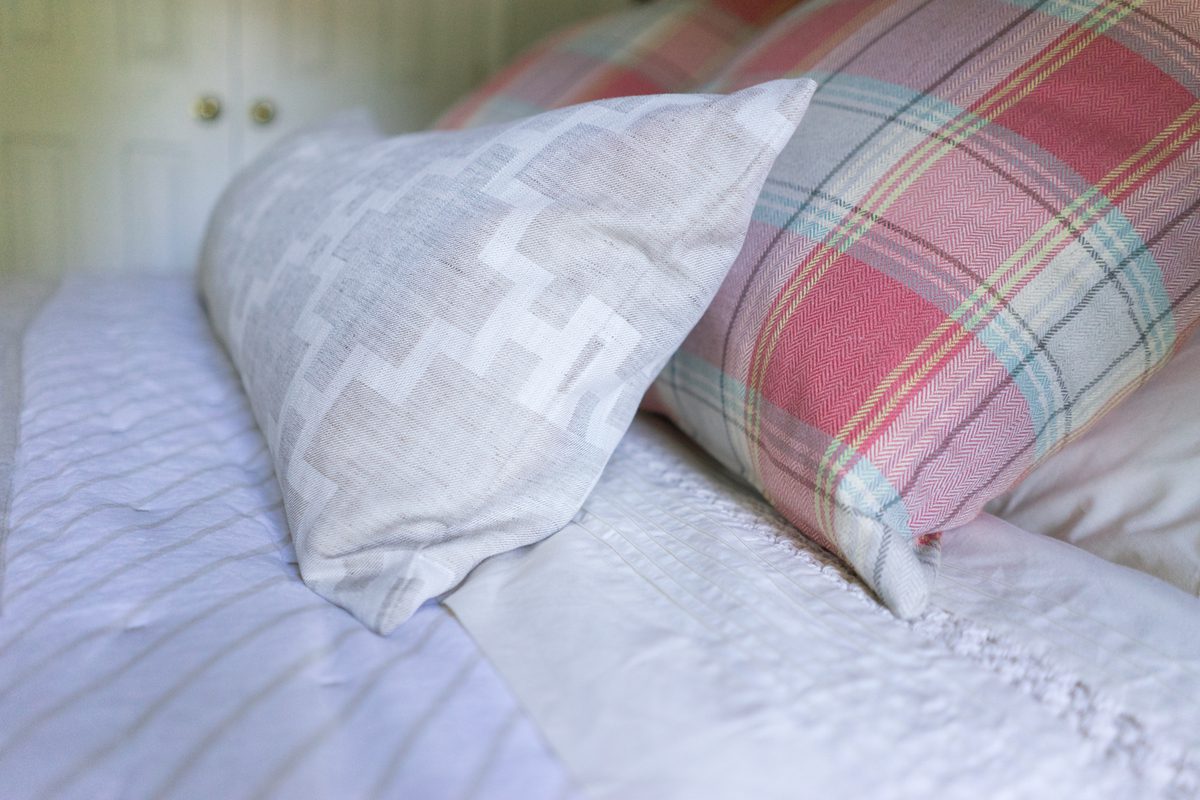 A close up of pillows on a bed