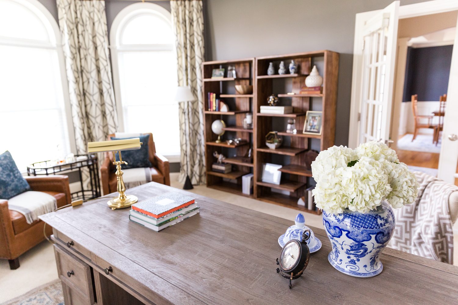 A living room with two bookcases and a table