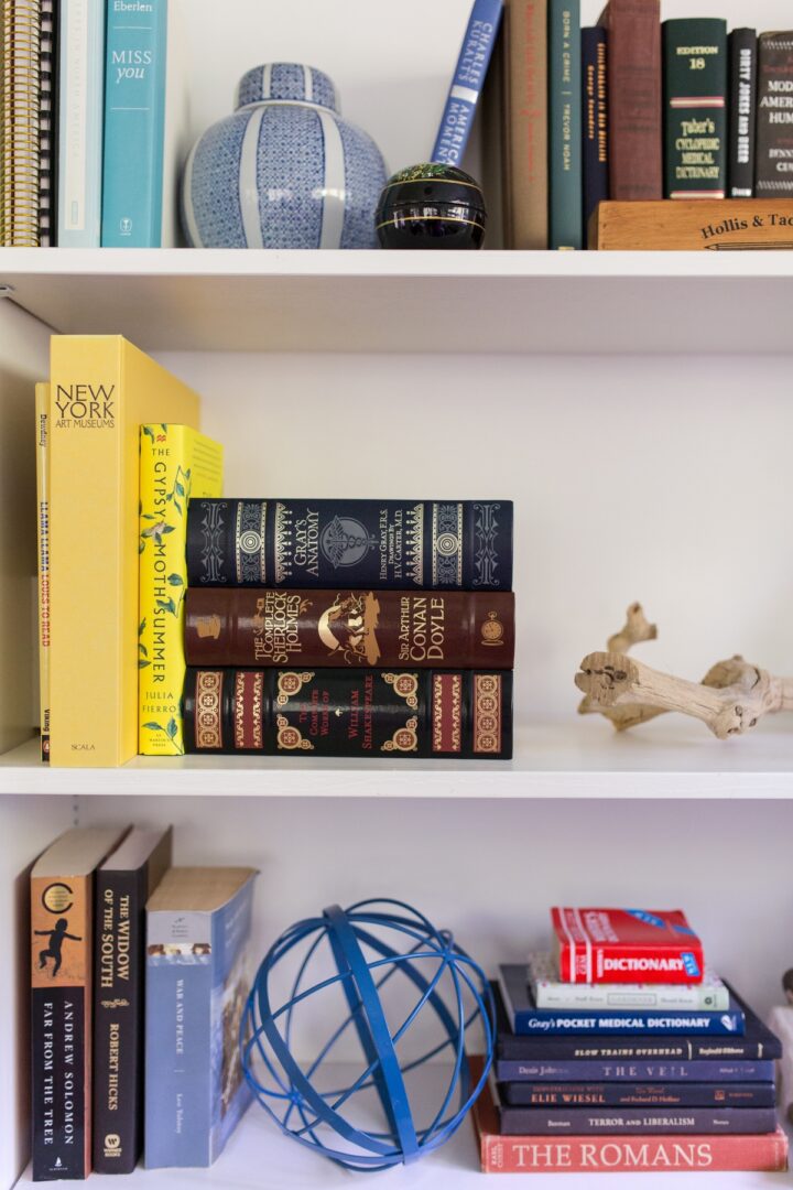 A bookshelf with books and other items on it.