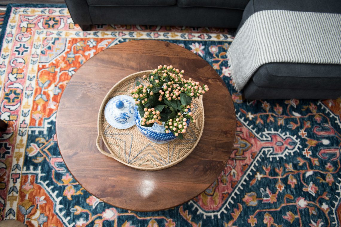 A coffee table with a plant in it