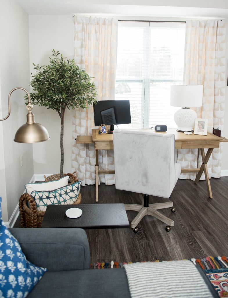 A living room with a desk and chair