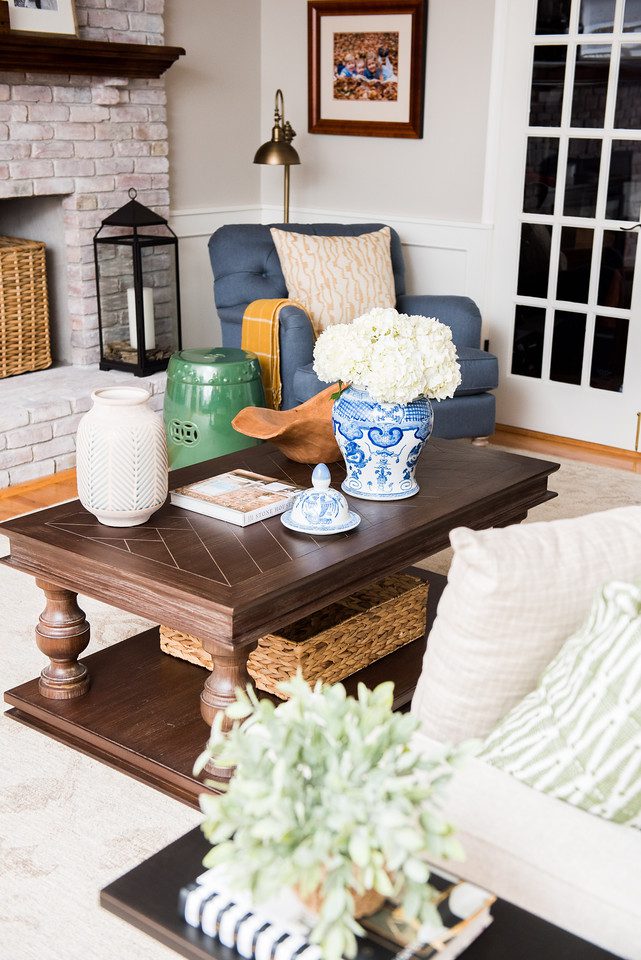 A living room with a couch, chair and coffee table.