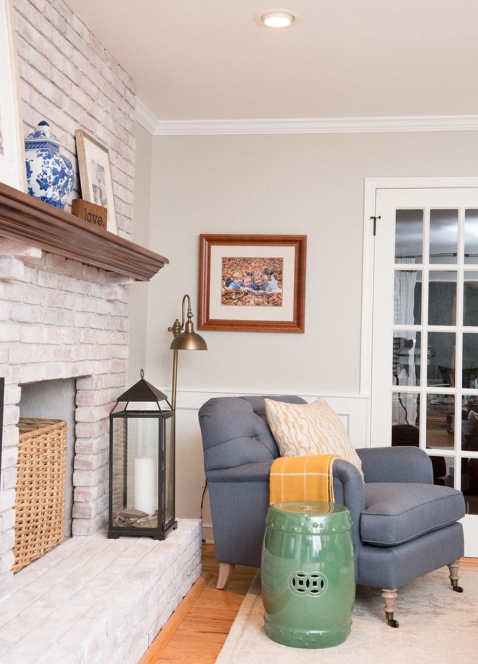 A living room with a fireplace and blue chair